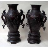 A large pair of Japanese Meiji bronze vases of two handled baluster form the bodies decorated with