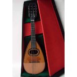 An early 20th century eight string Neapolitan style mandolin, painted and inlaid light wood tear