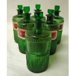 A set of six green glass pharmaceutical bottles with vertical ribbed body, five with red and gilt