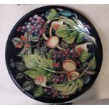 A Moorcroft pottery charger, tubeline decorated in the Queen's Choice design by Emma Bossons,