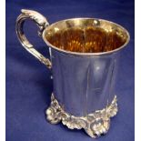 A Victorian silver tankard of lobed circular form with everted rim, leaf capped S scroll handle,