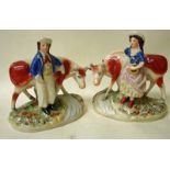 A pair of 19th century Staffordshire pottery figural groups modelled as a milk maid and a cow hand