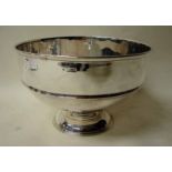 A large Edwardian silver footed fruit bowl of ribbed circular form on a stepped foot, London 1904,