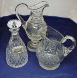 A Victorian cut glass water jug with diamond cut body, scroll handle and star cut pedestal base,