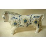 A Wedgwood stylised pottery model of a standing bull, designed by Arnold Machin, painted with flower