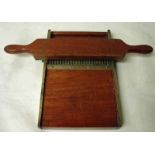 A 19th century mahogany and brass mounted chemist’s pill roller with double handle pin roller and