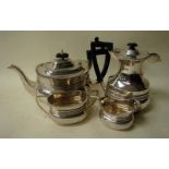 An Edwardian silver four piece tea service of rounded rectangular form with ribbed decoration,