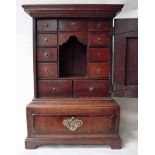 An eighteenth century oak and crossbanded table top cabinet, ogee moulded cornice above a hinged