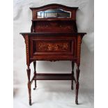 A late Victorian/Edwardian rosewood and inlaid cabinet of small proportions, the moulded edge