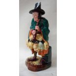 A Royal Doulton figure modelled as The Mask Seller, number HN2103, copyright 1952, 21cm high