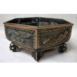 A Chinese bronze plant holder of hexagonal form, cast in relief with panels decorated with fish,