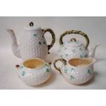 A Belleek porcelain four-piece tea service, of basket weave form with organic handles, shamrock