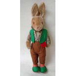 A Schuco Tricky Yes No Rabbit, circa 1950, vintage toy with green waistcoat, brown trousers, striped