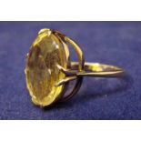 A 9ct gold ring set with large oval citrine, facet cut, two-tier mount, citrine 13mm long, ring size