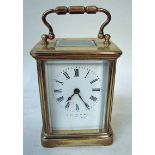 A late 19th/early 20th century brass carriage clock with gilt brass five panel case, white face with