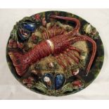 An early 20th century Majolica Palissy style wall plate, mottled green, decorated with an applied