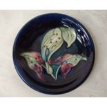 A Walter Moorcroft pottery dish of circular form, tubeline decorated in the Lords and Ladies pattern