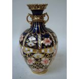 A Royal Crown Derby two-handle vase of narrow neck ovoid shape with castellated rim, decorated in