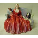 A Royal Doulton figural model depicting a seated lady, Sweet and Twenty, HN1298, 14cm high