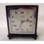 An Art Deco burr walnut cased mantel clock of square form, silvered square face inscribed Harrods