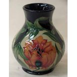 An early 21st century Moorcroft Pottery vase, tubeline decorated in the Fireflower pattern, designed
