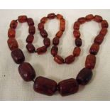 A large graduated amber bead necklace composed of thirty-nine ovoid beads, 66g, 70cm long