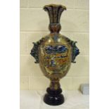 A large late 19th century Italian Maiolica pedestal vase decorated in blue, green, yellow and