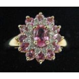 A modern 9ct gold diamond and pale ruby target style cluster ring, size P