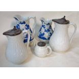 A graduated pair of Victorian press moulded water jugs, white stoneware with hinged pewter lids,