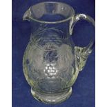 A crystal glass lemonade jug of baluster form with loop handle, engraved with fruiting vine