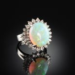 AN 18K WHITE GOLD, OPAL, AND DIAMOND LADY'S RING, set with one 11.1 x 13.4 millimeter white base