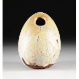 A GERMAN GLAZED EARTHENWARE LAVA GLAZE VESSEL, CIRCA 1955, in the form of an egg with cream and