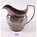 A silver milk jug with engraved band of flowers by Alexander Field, London 1801