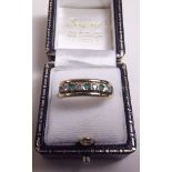 A 9 carat gold ring set emeralds and diamonds