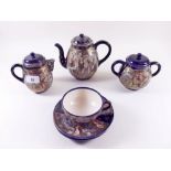 A Japanese satsuma teaset comprising: teapot, hot water jug, sugar, three cups and six saucers