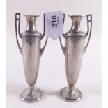 A pair of small continental white metal classical style two handled vases