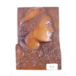 A continental carved wooden plaque depicting bust of a man amongst foliage - 23 x 16cm
