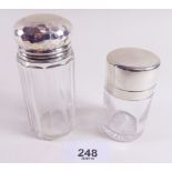 A glass and silver topped toiletry bottle and a similar smelling salts bottle