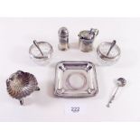 A group of five silver cruets, two salt spoons, pin dish and a silver plated shell form salt