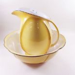 An Art Deco yellow toiletry jug and bowl set