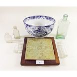 A blue and white bowl by Ridgeways, two tiles and five medicine bottles