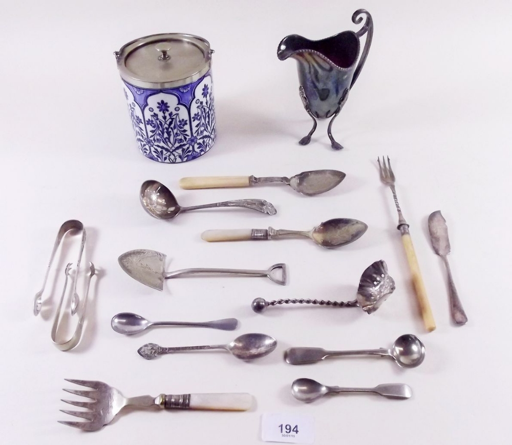 A silver plated blue and white biscuit barrel, a silver plated cream jug and various cutlery
