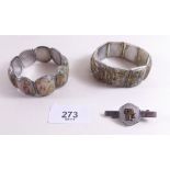 An Oriental white metal tie pin and two painted panel bracelets