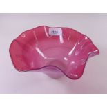 A cranberry glass frilled edge bowl, 18cm diameter