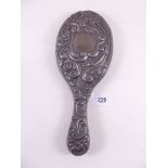A silver embossed hand mirror