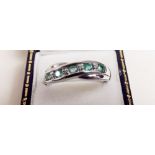 A silver five stone emerald ring