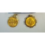 A box containing two half sovereigns with gold surrounds - detachable, George V 1913 and George V