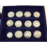 A Presentation case - MDM Crown Collections Ltd. including 12 silver commemorative coins Ref: