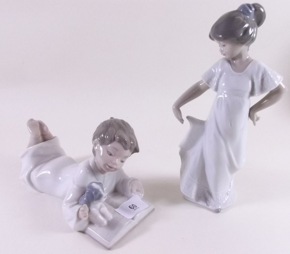 Two Nao figures - boy reading book and girl dancing