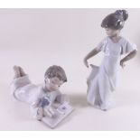 Two Nao figures - boy reading book and girl dancing